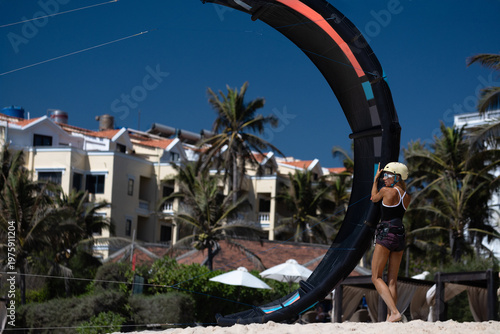 Woman Preparing Kite for Kitesurfing on the Beach