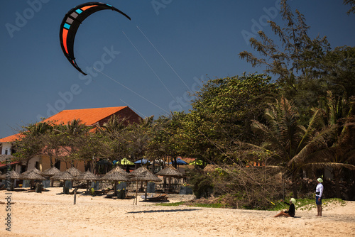 Kitesurfing Lesson on a Tropical Beach with Kite Flying in the Sky