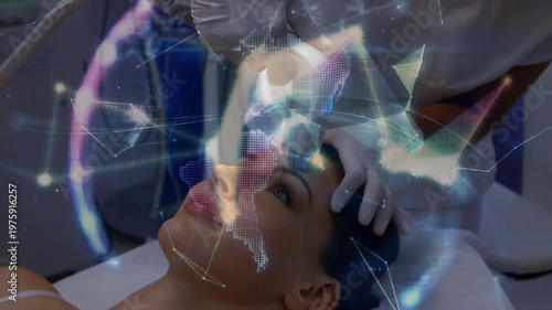 Tech holding patient and placing wand in clinic, causing digital mesh covering face to map skin