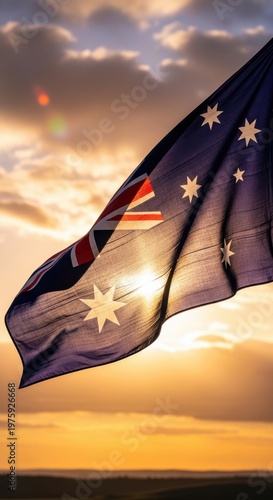 Australian flag waving in the wind at sunset with a beautiful cloudy sky