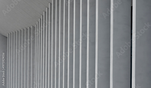 Obraz na plátně Close view of repeating vertical pillars creates abstract pattern on building facade