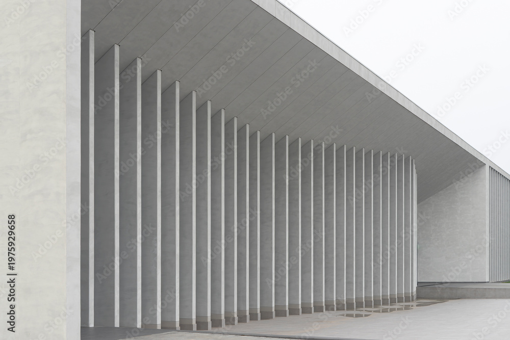 Fototapeta premium Curved modern building facade extends with continuous row of vertical columns. Architectural structure forms sweeping arc creating minimal urban exterior scene. Concept of contemporary design, space,