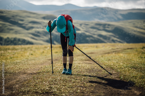 Bild auf Leinwand Sports injured knee woman trail runner running in grassland