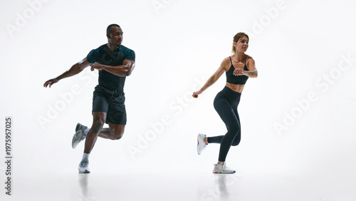Fotografie Fit couple performing rotational cardio movement exercise isolated on white background