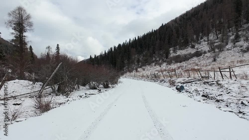 POV of driving car on snow covered mountain road in snowing day in Sichuan, China, 4k real time footage travel concept.