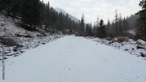 POV of driving car on snow covered mountain road in snowing day in Sichuan, China, 4k real time footage travel concept.