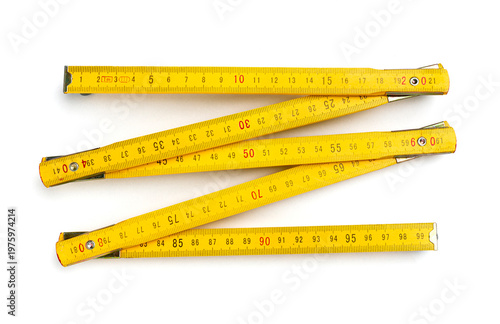 Foto Yellow wooden folding ruler isolated on white