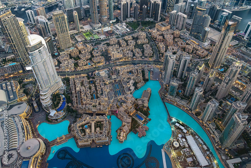 Aerial view of Dubai downtown skyline with turquoise canal and modern skyscrapers