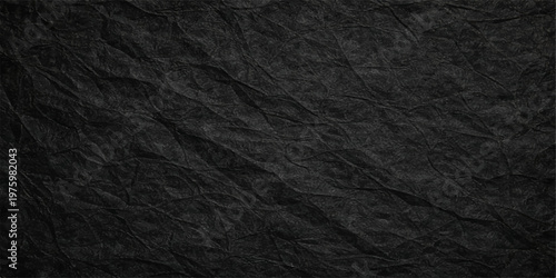 A dark textured background featuring a black leather material surface with a rough macro pattern and grunge textile design for a vintage fabric wallpaper backdrop