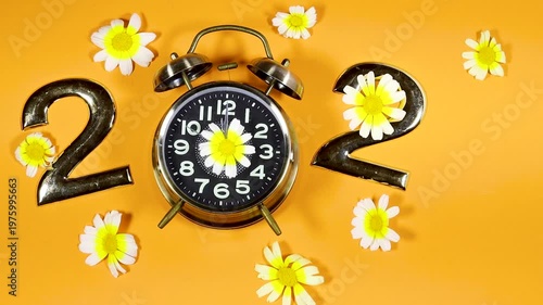 Bright Floral 2027 Concept With Alarm Clock and Daisies on Orange Background