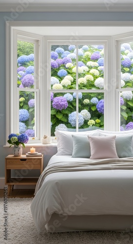 Tranquil bedroom with a large bay window offering a beautiful view of lush blooming hydrangeas, creating a serene and picturesque home interior
