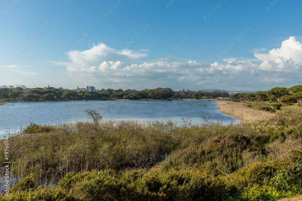 Obraz premium Scenic Lagoon Landscape and Dirt Road in Quarteira Algarve Portugal
