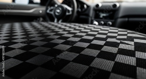 Close-up of a checkered car seat cover inside a vehicle.