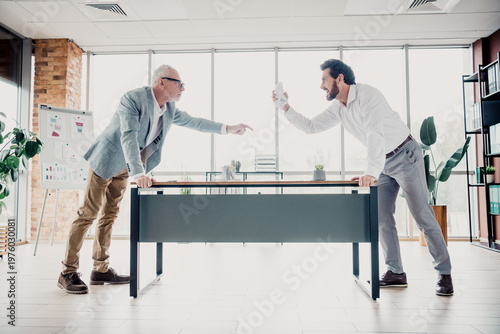 Φωτογραφία Business disagreement in a modern office two colleagues confront each other acro