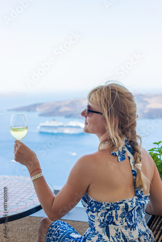 Woman with glass and wine in Greece in restaurant. Selective focus.