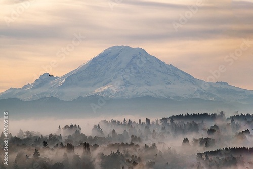 An airplane flies past Mount Rainier on a foggy morning