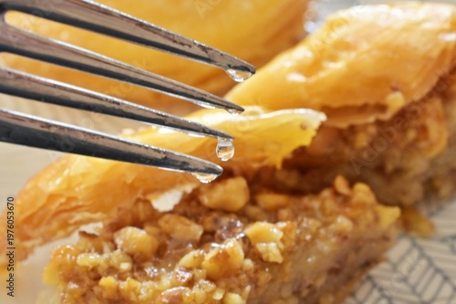 fork in front of pieces of homamade turkish baklava served on a plate