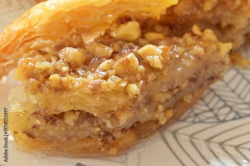layers and walnuts  of homamade turkish baklava served on a plate