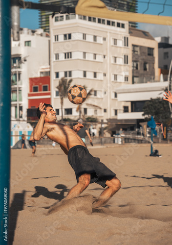 young man playing footvolley in Las Canteras beach. Las Palmas de Gran Canaria. Canary Islands. Spain.