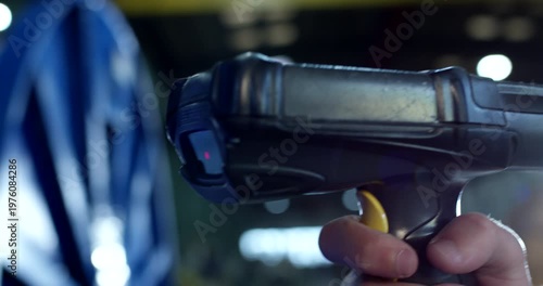 Close up of a hand-held industrial barcode scanner or data terminal used in a warehouse facility