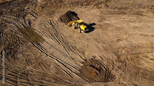 Aerial View of a Yellow Front Loader Working at an Excavation Site