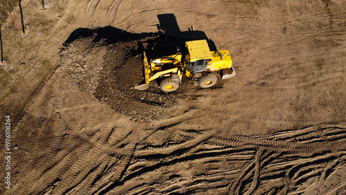Aerial View of a Yellow Front Loader Working at an Excavation Site