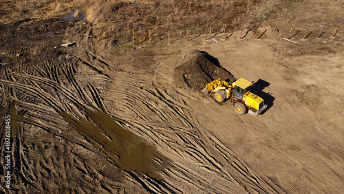 Aerial View of a Yellow Front Loader Working at an Excavation Site