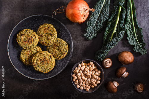 Raw vegetables on textured dark surface