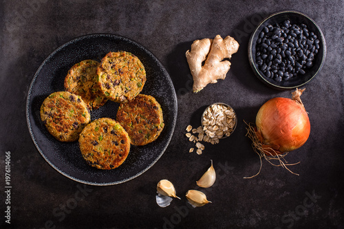 Raw vegetables on textured dark surface