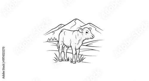 A young cow stands in a grassy field with mountains in the background