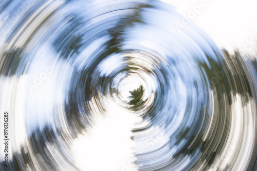 фотографія Abstract circular motion blur of spring flowers and green foliage creating a cre