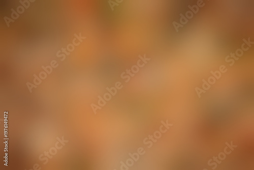 Blurred warm autumn background with fallen leaves, out of focus, gradient backdrop