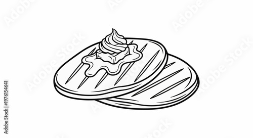 Two grilled pancakes topped with a pat of melting butter