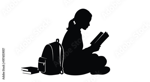 Silhouette of a young girl sitting and reading a book with a backpack and books nearby