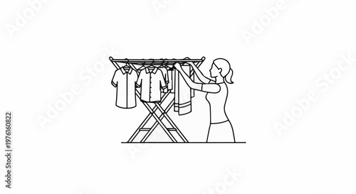 Person hanging laundry on a drying rack