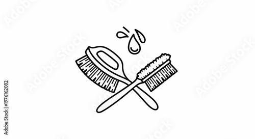 Two crossed cleaning brushes with water droplets above