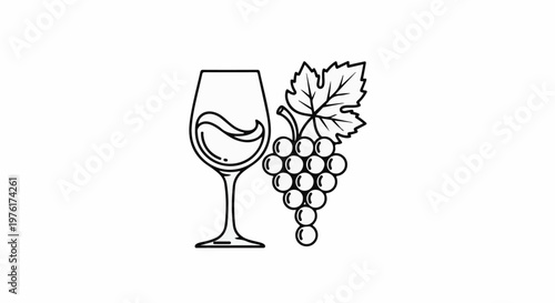 A glass filled with wine sits next to a bunch of grapes and a leaf