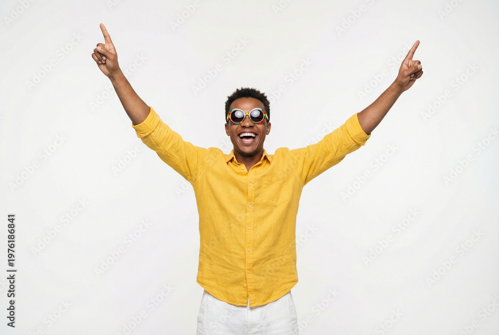 Naklejka premium Young black man celebrating with raised arms and cheerful expression 