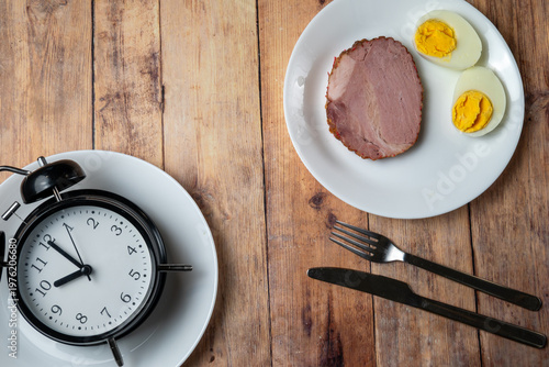 Intermittent fasting concept with meal and clock