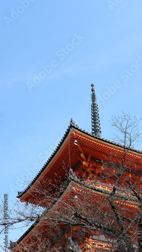 Vibrant Orange Pagoda Tower Against Blue Sky in Spring