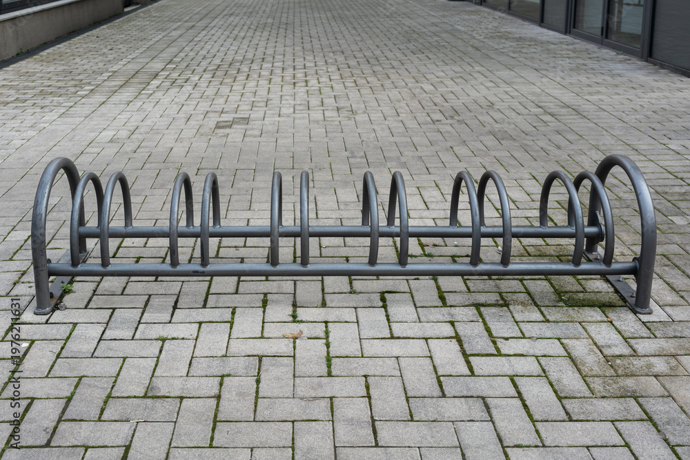custom made wallpaper toronto digitalWide Empty Bicycle Parking In Courtyard With Long Row Of Steel Loops, Expansive Paving And Muted Sky, Shows Sustainable Mobility Infrastructure Awaiting Commuters, Clean Geometry And Civic Space