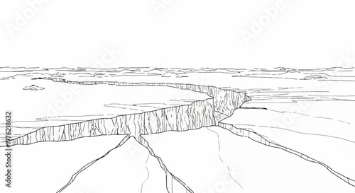 Cracked ice sheet stretching into the distance with snow-covered terrain