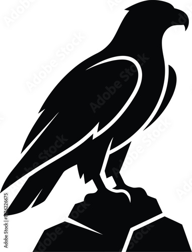 Black silhouette eagle standing on a rock looking to the right side