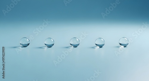 Minimalist macro composition of perfectly spaced water droplets on a tranquil soft blue background.