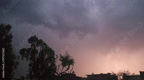A dark scene featuring a lightening & thunder faintly illuminated object with a noticeable reflection and subtle highlights in the background