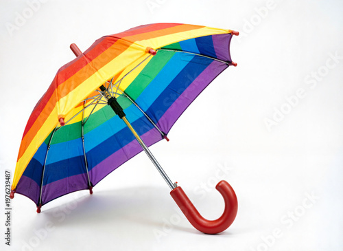 child's umbrella with a rainbow striped canopy on white