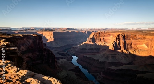 Majestic grand canyon landscape with winding river at sunset.