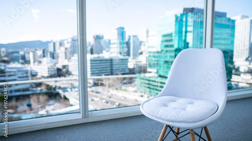 White chair positioned by window overlooking urban buildings, symbolizing opportunity, future, and corporate environment