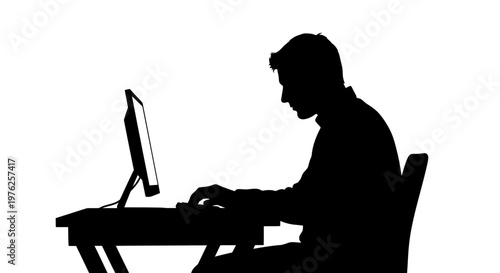 Silhouette of a Person Working on a Computer at a Desk