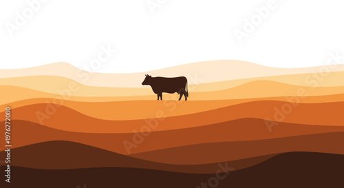 Silhouette of a cow standing on a hill with layered brown landscape